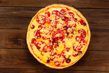 Appetizing pizza on a wooden background
