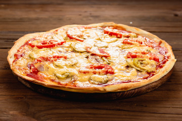Appetizing pizza on a wooden background
