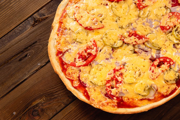 Appetizing pizza on a wooden background