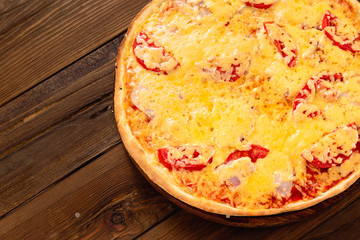 Appetizing pizza on a wooden background