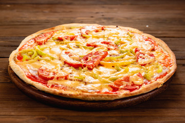 Appetizing pizza on a wooden background