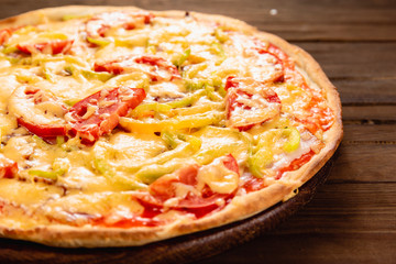 Appetizing pizza on a wooden background