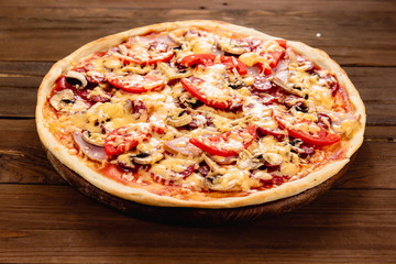 Appetizing pizza on a wooden background