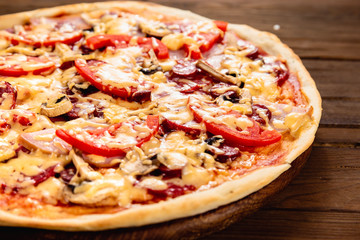 Appetizing pizza on a wooden background