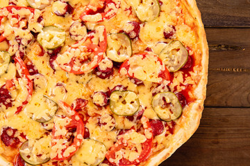 Appetizing pizza on a wooden background