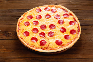Appetizing pizza on a wooden background