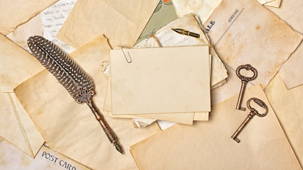 Vintage composition with bunch of old letters and quill pen