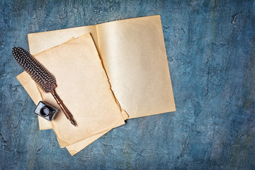 Mock up of empty vintage paper sheets with quill pen and bottle of black ink