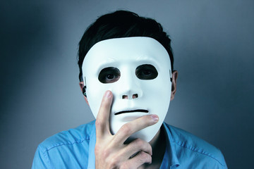 man holds mask in his hand