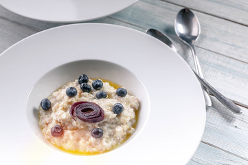Close-Up Oatmeal with butter and berries. Delicious and healthy breakfast concept