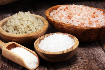 sea salt in bowl. Crystals of salt on table and himalayan salt.