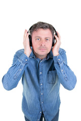 Portrait of a cool handsome man listening to music with headphones on white background
