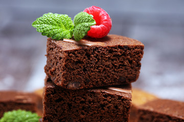 chocolate brownie cake dessert with raspberry and spices on a rustic background