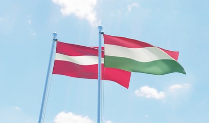 Hungary and Latvia, two flags waving against blue sky. 3d image