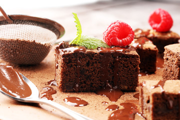 chocolate brownie cake dessert with raspberry and spices on a rustic background