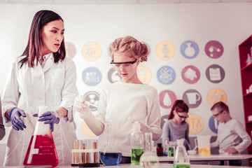 Elementary school teacher following her children during experiment