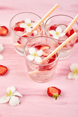 Strawberry detox water with jasmine flower. Summer iced drink or tea.
