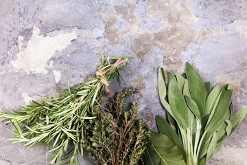 Homegrown and aromatic herbs on rustic background with rosemary and basil