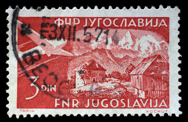 Stamp issued in Yugoslavia shows Gozd-Martuljak, Airplanes and Landscapes series, circa 1951.