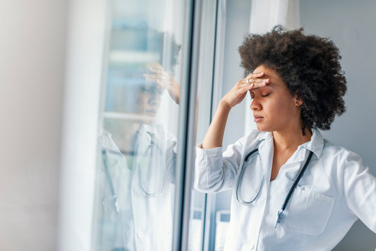 Nurse Doctor With Migraine Overworked, Overstressed Isolated Background Hospital Hall Corridor