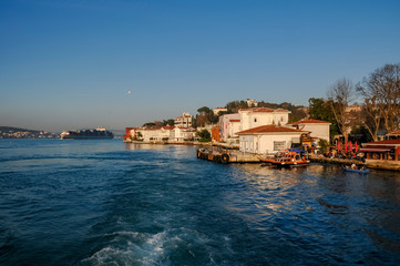 Fototapeta na wymiar both shores of bosphorus strait are full of residential houses which local people use as weekend residences.
