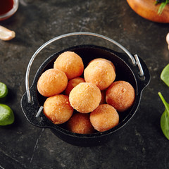 Cheese Balls in Metal Bowler on Dark Background