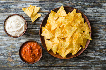 Nachos corn chips with spicy tomato and cheese sauces.