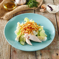 Salad with Chicken, Egg and Crispy Potatoes in Blue Plate