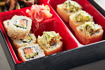 Fresh Food Portion in Japanese Bento Box with Sushi Rolls