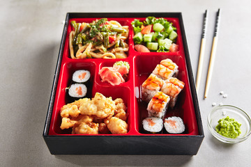 Fresh Food Portion in Japanese Bento Box with Sushi Rolls