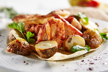Grilled Pork with Potato, Spices and Pita Bread on Rustic Background