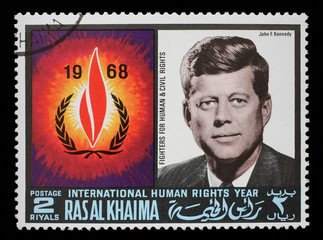 Stamp issued in the Ras al Khaimah shows John F. Kennedy (1917-1963), International Human Rights Year, circa 1968. - obrazy, fototapety, plakaty