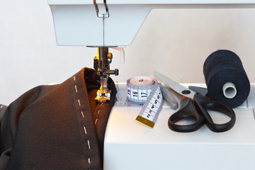 Sewing at home. Processing the underside of the pants on the sewing machine. Accessoriesfor woork:...