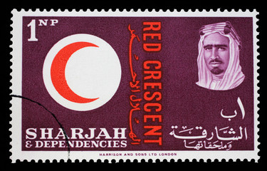 Stamp issued in the Sharjah shows Red Crescent Emblem, portrait of Sheik Saqr bin Sultan al Qasimi, 100 years International Red Cross, circa 1963.