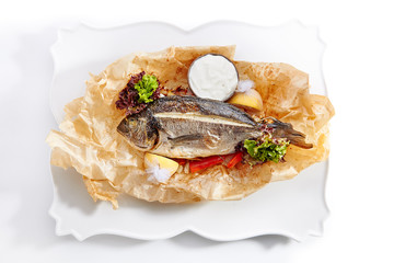 Dorado Baked with Tomato Salsa, Greens and Olives Isolated