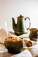 sauerkraut in a glossy cup on the table, on a light background