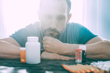 Distressed upset man taking different types of pills