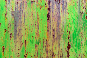 Detail of green painted, old, metal, rusty doors. Grunge texture of rusty metal with scratches 