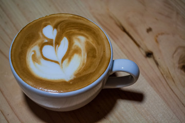 Cappuccino cup with latte art. Coffee with milk. Work barista. Fresh drink with caffeine.