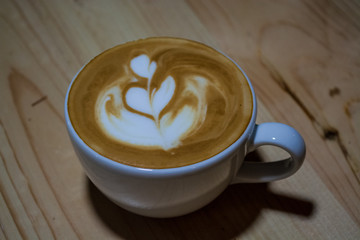 Cappuccino cup with latte art. Coffee with milk. Work barista. Fresh drink with caffeine.