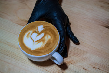 Cappuccino cup with latte art. Coffee with milk. Work barista. Fresh drink with caffeine.