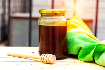 jar of  pure Honey and wooden dripper