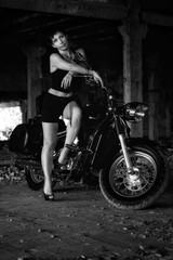 Fototapeta na wymiar Strong independent , self-sufficient girl with male fascination on chopper motorcycle, international womens day concept