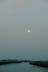 Moon above a river