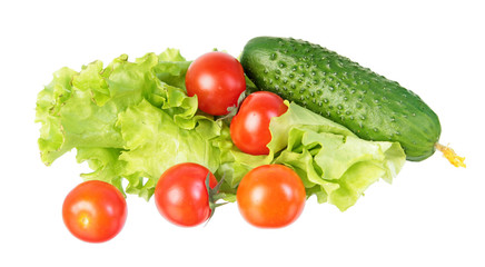 Fresh green cucumber, red tomatoes and green salad leaves isolated on white background. Ingredients for vegetable salad