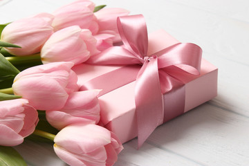  Beautiful composition for the Day of Mother on wooden background top view. Flowers, greeting card, gift.
