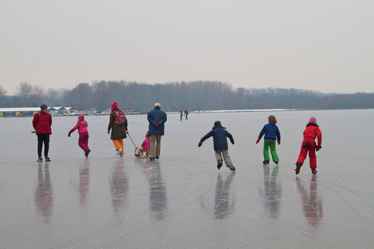 Kids, teenagers and grown-up enjoying ice scating in Amsterdam the Netherlands.