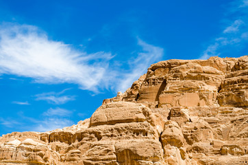 Fototapeta premium high rocky mountains in the desert against the blue sky and white clouds in Egypt Dahab South Sinai