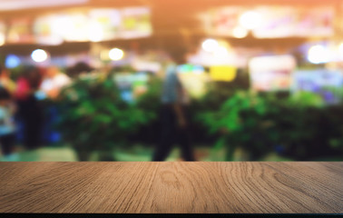 Empty dark wooden table in front of abstract blurred bokeh background of restaurant . can be used for display or montage your products.Mock up for space.