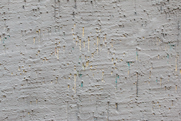 gray concrete wall with bubbles and yellow and green lines, abstract background.